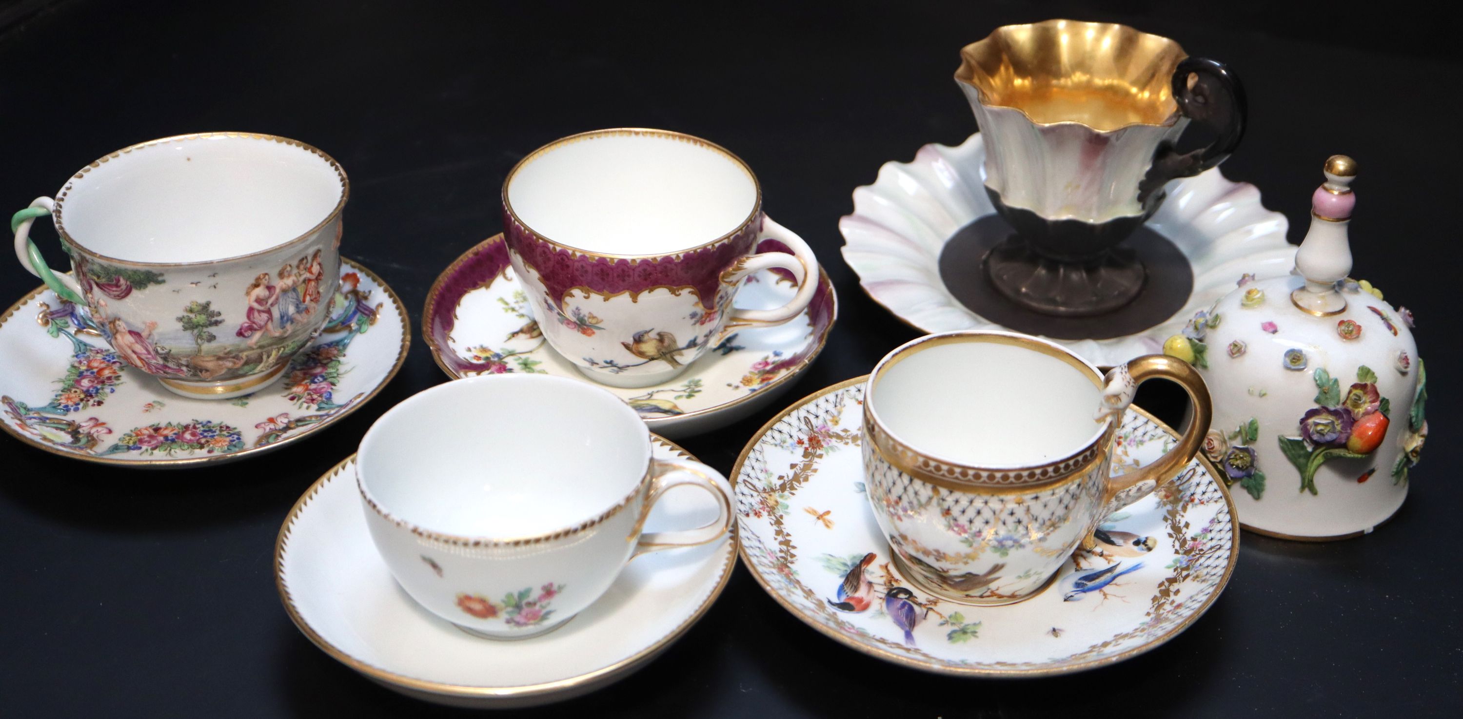 Five Continental porcelain cups and saucers, 19th century,